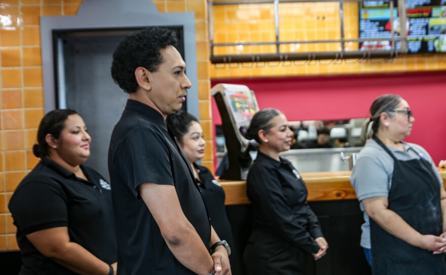 Angel (front) and his coworkers stood at attention as Hobbs greeted Chile Pepper's owners and employees.