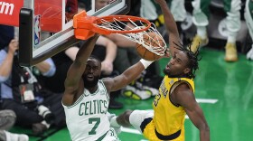 Boston Celtics guard Jaylen Brown (7) dunks the ball against Indiana Pacers forward Aaron Nesmith (23) during the first quarter of Game 1 of the NBA Eastern Conference basketball finals, Tuesday, May 21, 2024, in Boston. (AP Photo/Michael Dwyer)