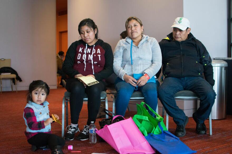 A family waits to speak with an immigration attorney at a free legal clinic hosted by the City of Seattle