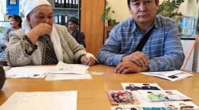 Kalida Akytkhan, pictured with her son Parkhat Rakhymbergen, has two sons and two daughter-in-laws who have been detained in re-education camps in Xinjiang. She brought photos of her family to the offices of rights organization Atazhurt in Almaty.