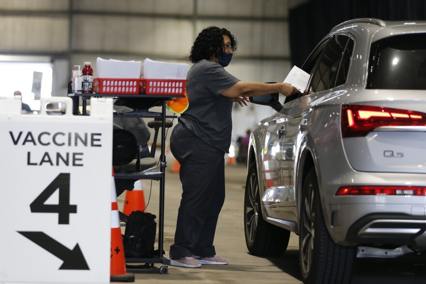 Judy Shavers administers a coronavirus vaccine at the drive-thru clinic Thursday, June 10, 2021, in Columbus, Ohio. 