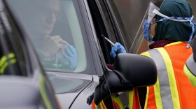 A healthcare worker prepares to administer the Pfizer COVID-19 vaccine Thursday, Feb. 11, 2021 at PNC Arena in Raleigh, N.C. Wake County Health Department workers along with nurses and volunteers from area hospitals distributed vaccines to persons with appointments during the drive through event. Since North Carolina began administering the vaccine in December, more than 1 million people have gotten their first doses. 