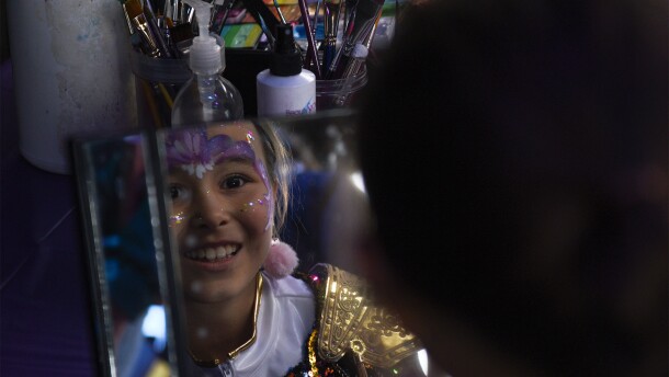Madelyn Lee, 9, looks in the mirror after getting her face painted during the Kpop Demon Hunters tribute event on Sunday, Oct. 26, 2025, at Rose Music Hall in Columbia. Many children dressed up in character costumes for the event.