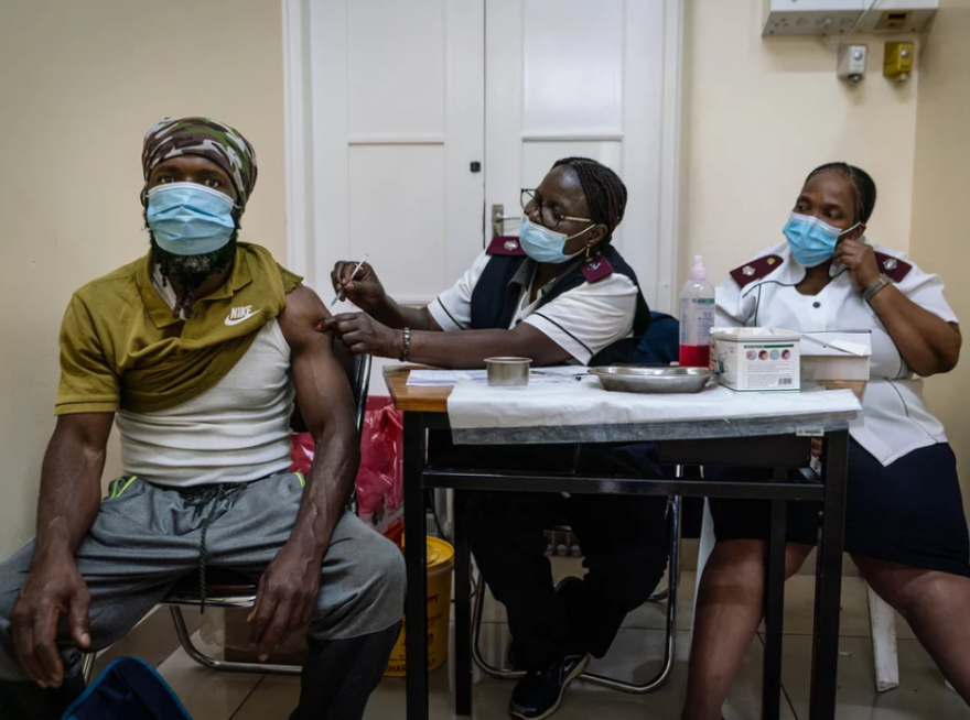 A man is vaccinated against COVID-19 at a clinic in Johannesburg, South Africa. The omicron variant appears to be driving a surge in South Africa. New studies suggest that vaccines might not be as effective against this variant but that a booster shot can be helpful.Shiraaz Mohamed/AP