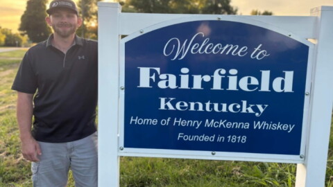 A recent photo of Herbie Hardin by the Fairfield, Kentucky sign.
