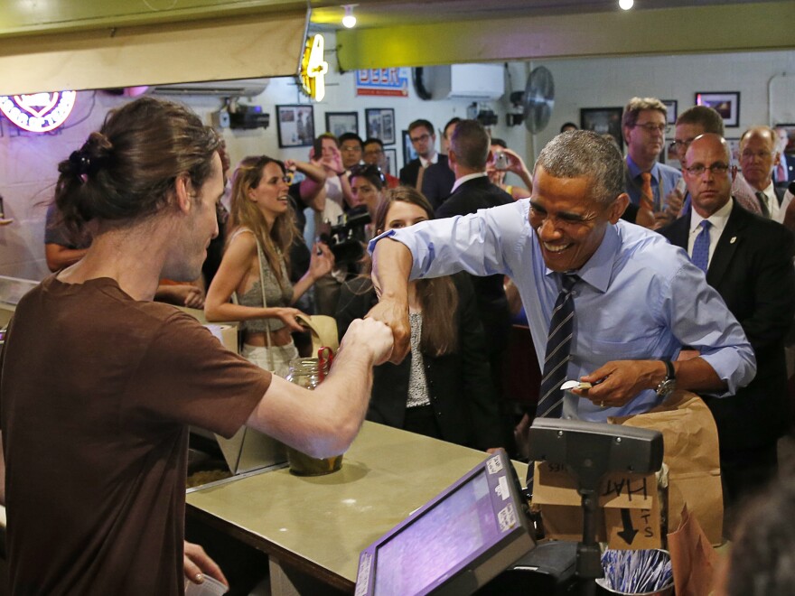 President Barack Obama fist bumps a Franklin Barbecue employee in Austin, Texas.