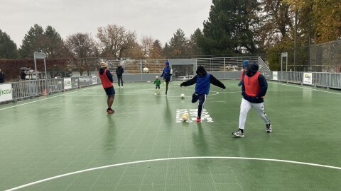 Players of all ages celebrate the opening of Hope Soccer 2026's new mini pitch at Grant Park with a friendly scrimmage.