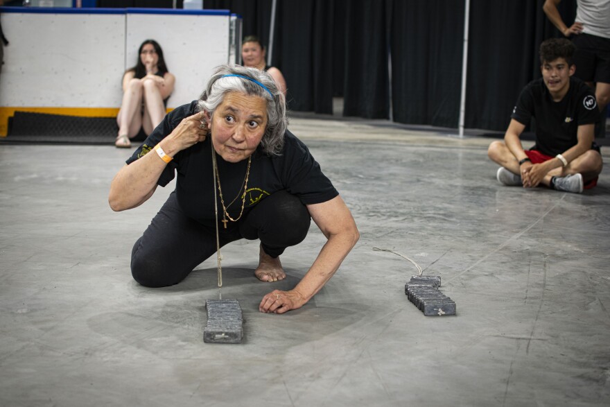 Sheila Rendazzo prepares to lift up 16 pounds of metal with her ear at the World Eskimo-Indian Olympics qualifier on July 19, 2025.