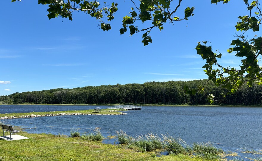  Blue lake is shown on a sunny day.