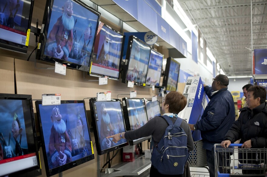 Shoppers look at televisions at a Walmart during Black Friday sales in 2012 in Quincy, Mass.