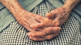 Eldery woman with hands folded 