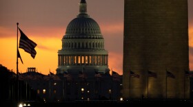 The base of the Washington Monument and the dome of the U.S. Capitol are seen at dawn on Wednesday, Oct. 1, 2025, in Washington.