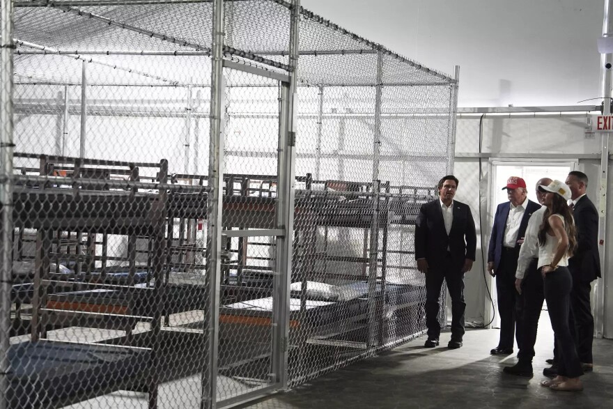 President Donald Trump, Gov. Ron DeSantis, R-Fla., and Homeland Security Secretary Kristi Noem, and others, tour "Alligator Alcatraz," a new migrant detention facility at Dade-Collier Training and Transition facility, Tuesday, July 1, 2025, in Ochopee, Fla.