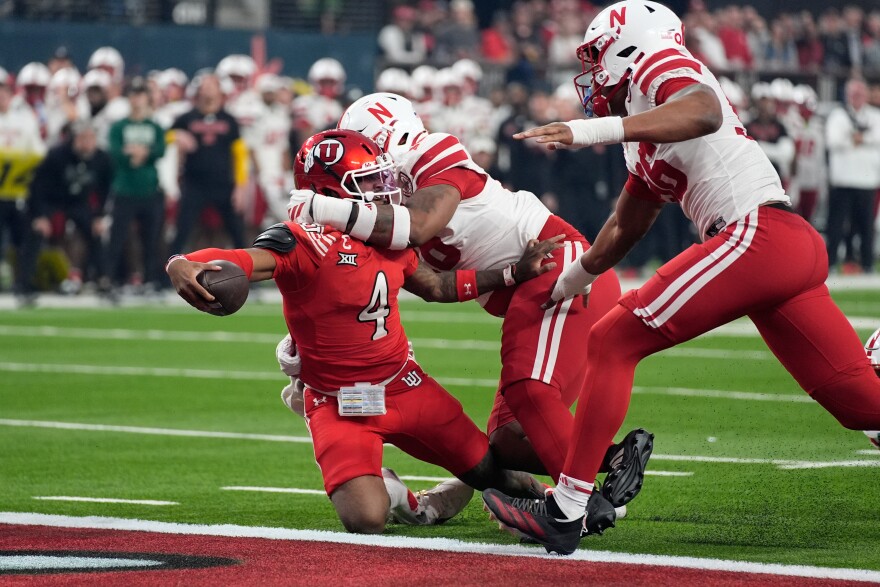 Utah quarterback Devon Dampier (4) scores a touchdown against Nebraska during the first half of the Las Vegas Bowl NCAA college football game Wednesday, Dec. 31, 2025, in Las Vegas.