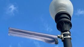 The remains of a "Top 5" banner after its theft are seen atop a light pole on the University of Florida campus on Sept. 15, 2022. The school said 14 of 19 banners have been stolen in a wave of thefts the school seems not to be eager to solve. (Photo by Brandon Meyer)