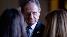 State Rep. Rick Miller, R-Sugarland, speaks with colleagues on the House floor during the House School Finance plan deliberations on April 3, 2019.