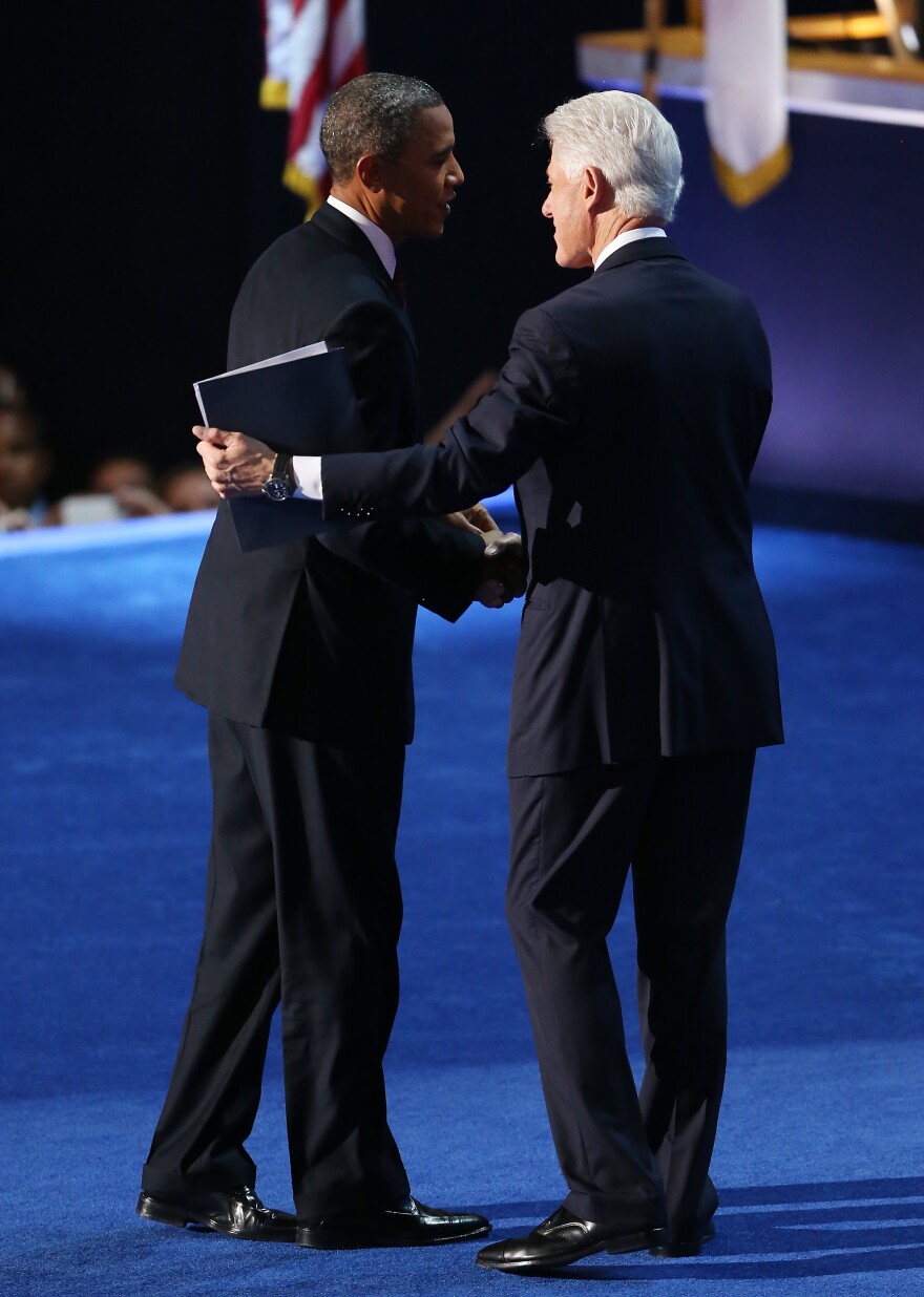 President Obama greets former President Bill Clinton onstage at the Democratic National Convention.