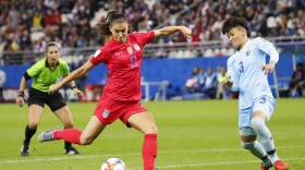 U.S. forward Alex Morgan shoots and scores past Thailand's Natthakarn Chinwong on Tuesday in Reims, France, in the group stage of the Women's World Cup.