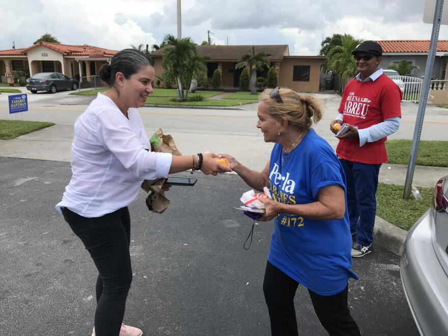 Eleane Sosa-Bruzon, who is running for Miami-Dade County Court judge, Group 33, handed out sandwiches to volunteers Tuesday.