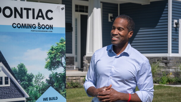 Congressman John James (R-MI 10) stands outside a newly-constructed home in Pontiac in September 2026.