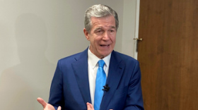North Carolina Gov. Roy Cooper speaks with reporters after the Council of State meeting at the Department of Transportation headquarters in Raleigh, N.C., Tuesday, Aug. 1, 2023. Cooper said he's not convinced that details within a tax-cut agreement reached between Senate leader Phil Berger and House Speaker Tim Moore will protect the state from revenue shortfalls.