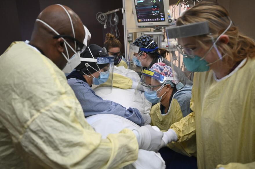 Critical care nurses and respiratory therapists flip a COVID-19 patient upright in North Memorial's South Six and South Seven Intensive Care Units on Monday, Dec. 7, 2020 at North Memorial Health Hospital in Robbinsdale, Minn. Hospitals in Michigan and Minnesota on Tuesday, Nov. 16, 2021, reported a wave of COVID-19 patients not seen in months as beds were filled with unvaccinated people and health care leaders warned that staff were being worn down by yet another surge.