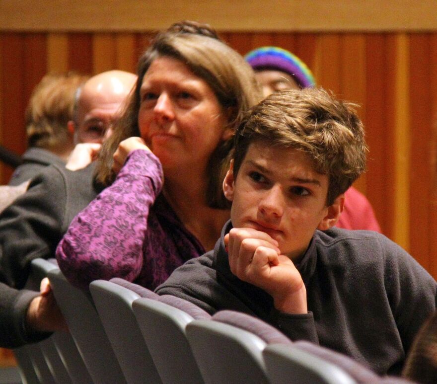 John Cassell and his mother listen to a neighbor during VPR's Woodstock Tell Me More Tour event.