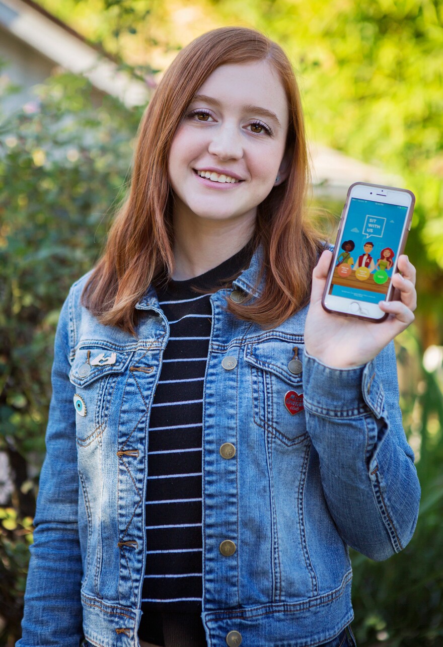 Natalie Hampton shows off the Sit With Us app.
