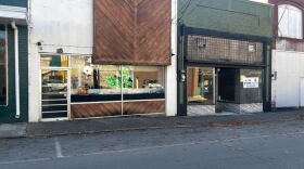 A row of older buildings line a city street.
