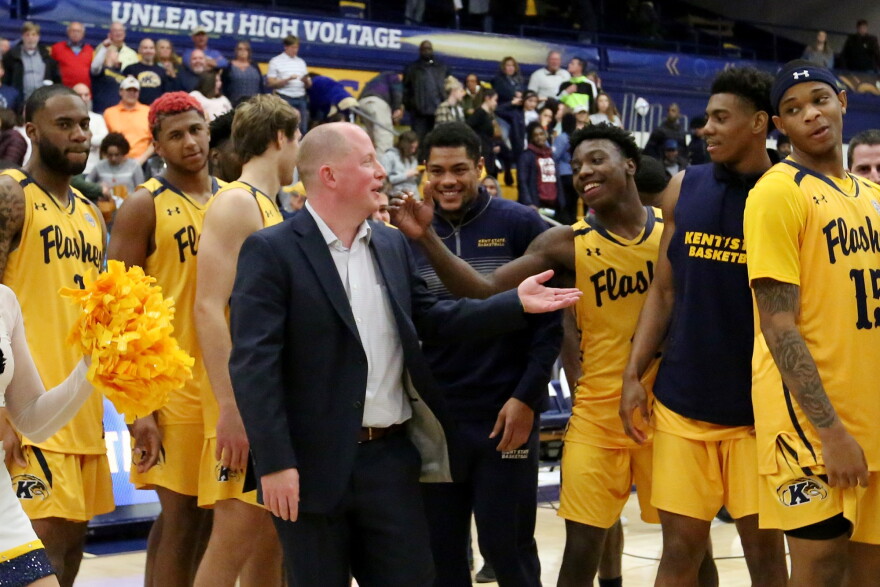 Kent State Men's Basketball coach Rob Senderoff is congratulated by team members earlier this season.