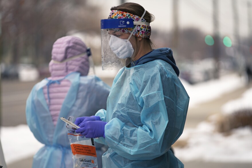 FILE - A nurse prepares for a COVID-19 test outside the Salt Lake County Health Department, Dec. 20, 2022, in Salt Lake City. The declaration of a COVID-19 public health emergency three years ago changed the lives of millions of Americans by offering increased health care coverage, beefed up food assistance and universal access to coronavirus vaccines and tests. Much of that is now coming to an end, with President Joe Biden's administration saying it plans to end the emergencies declared around the pandemic on May 11, 2023. (AP Photo/Rick Bowmer, File)