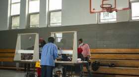 Poll workers sit behind plexiglass barriers during primary elections on June 2, 2020 in Philadelphia, Pennsylvania. (Jessica Kourkounis/Getty Images)
