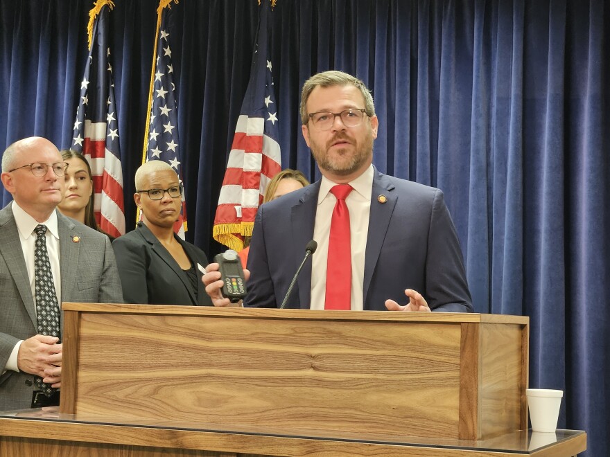 Rep. Mike Schietzelt, R-Wake, holds an ignition interlock device that's used to keep drunk drivers from starting their cars.