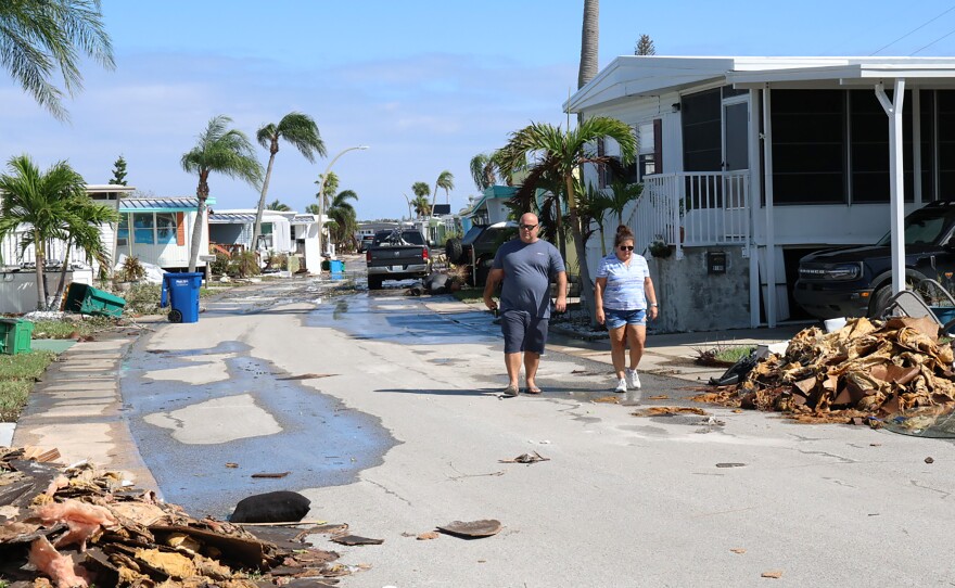 Terry and Jodi Faucher assess the damage from Hurricane Milton as they walk through the Harbor Lights Mobile Home Park in Seminole, Fla., Oct. 10, 2024. (Photo by Kaley Mantz)