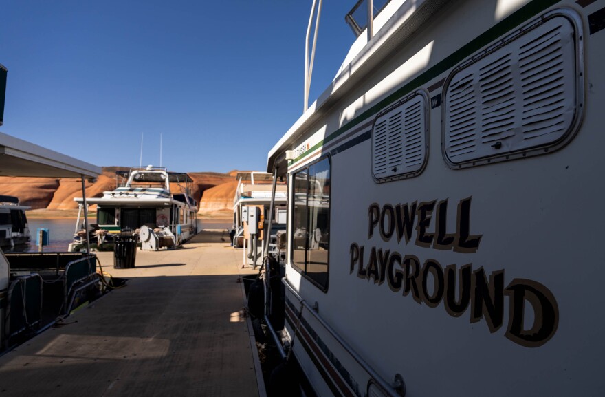 Large pontoon boats sit on the land.