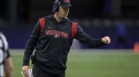 FILE - Western Kentucky head coach Tyson Helton fist bumps his players during the New Orleans Bowl NCAA football game against South Alabama in New Orleans, Dec. 21, 2022. Conference USA heads into the season in transition. In some respects, it got smaller, with six teams defecting to the American Athletic Conference. In others, it got bigger, adding large markets to show off its product. (AP Photo/Matthew Hinton, File)