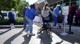 In this Jan. 19, 2021, photo, Robert Owens, 90, stands in line with other residents to receive the Pfizer-BioNTech COVID-19 vaccine at John Knox Village in Pompano Beach.