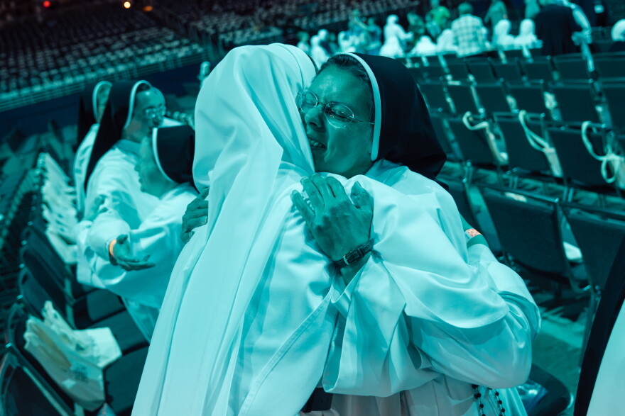 Dominican Sisters of Mary Mother of the Eucharist's Agnes Maria, right, is embraced by Sister Angela Marie, left, before the the beatification Mass for the late Archbishop Fulton J. Sheen on Thursday at the Dome at America's Center in downtown St. Louis.
