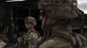 U.S Army Sgt. Brenden Richards monitors the area while standing next to a Stryker combat vehicle Wednesday, July 23, 2025, in Sunland Park, N.M. (AP Photo/Jae C. Hong)