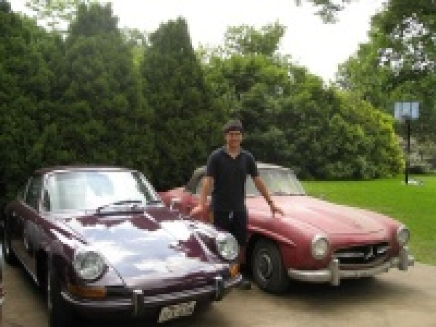 Erick vant' Westeinde, between red 1956 Mercedes Roadster and 1973 Purple Porsche 911.