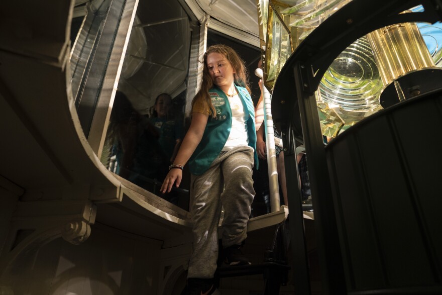 Elizabeth Pedroza, 9, goes downstairs after seeing The Third Order Fresnel Lens up close, as seen in the photo, after it was relit at the Port Isabel Lighthouse Historic Site in Port Isabel, Texas on Friday, Dec. 9, 2022. This is the first time in 117 years that the lens is being relit after the Texas Historical Commission and the Port Isabel Lighthouse State Historic Site were able to obtain a new lens for the lighthouse. &#13;Verónica G. Cárdenas for Texas Public Radio