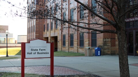 A photo outside the State Farm Hall of Business on the ISU campus. The sun is out and the sidewalk is empty.
