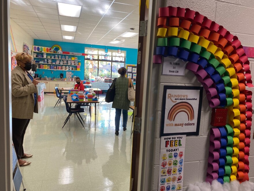 Our Lady of the Assumption Principal Allana-Rae Ramkissoon shows Milagros Macher and 9-year-old Alberto the art classroom.