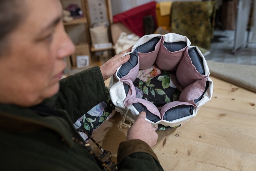 Gloria Lucchesi shows a cooking container in the shop of the association Filo & Fibra in San Casciano dei Bagni on Nov. 12.