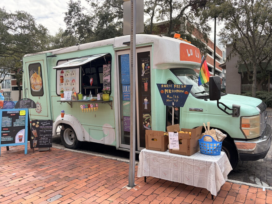 A green food truck sells fresh fruit and ice cream at the Gainesville Pride Festival on Saturday, Oct. 3, 2026. (Madison Middleton/WUFT News)
