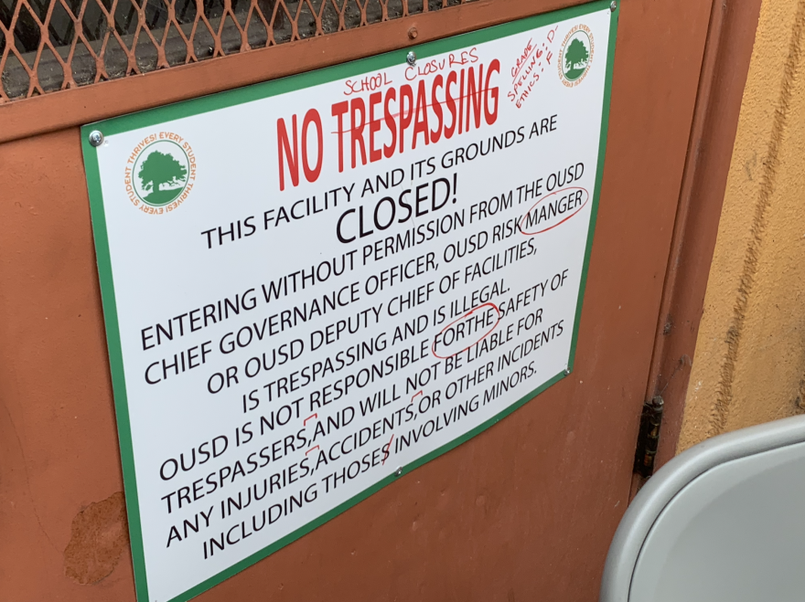 A "No Trespassing" sign posted by the district is proofread and edited by volunteers at the Community School.