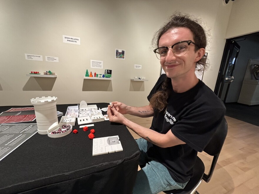 NKU grad student Ben Lloyd shows the game he created with the Build a Better Book Program at NKU for individuals who are BVI.