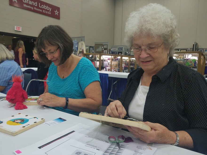 Lisa Schoen (Left) and Betty Bell (Right) demonstrate needlepointing at the state fair