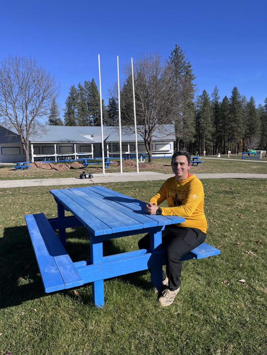 Danny Brigman sitting outside at the Wellpinit Powwow Grounds.
