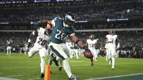 Philadelphia Eagles running back Saquon Barkley (26) scores during the second half of an NFL football game against the Washington Commanders Thursday, Nov. 14, 2024, in Philadelphia. (AP Photo/Matt Slocum)